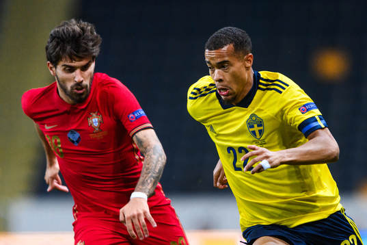 Ruben Neves of Portugal and Robin Quaison of Sweden