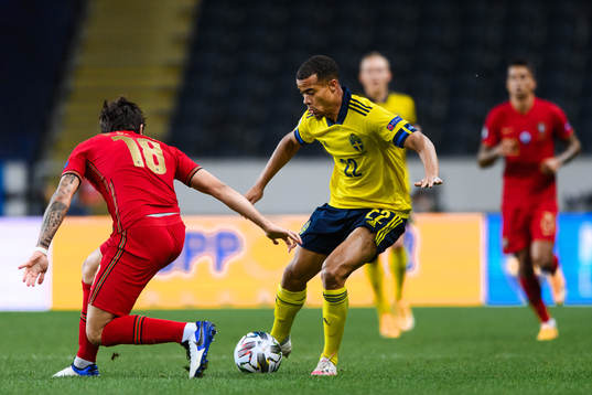 Ruben Neves of Portugal and Robin Quaison of Sweden