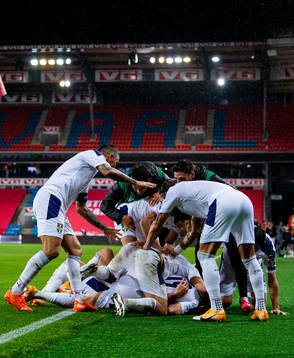 Sergej Milinkovic-Savic of Serbia celebrates with teammates after scoring 1-2