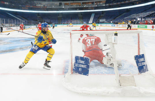 Max Friberg #12, SWE scores goal behind Patrik Bartosak
