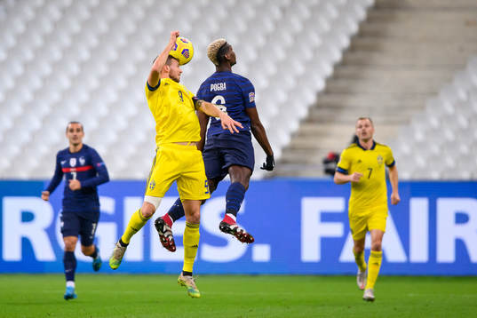 Marcus Berg of Sweden and Paul Pogba of France