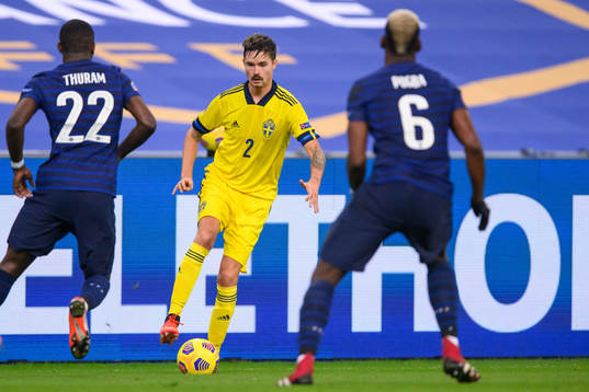 Mikael Lustig of Sweden against Marcus Thuram and Paul