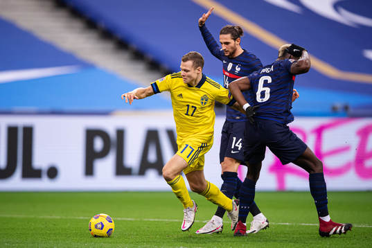 Viktor Claesson of Sweden breaks through Adrien Rabiot and