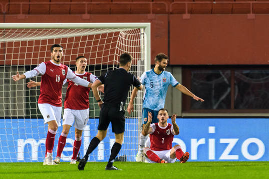 Adrian Grbic and Marko Arnautovic of Austria reacts against referee Benoit Bastien