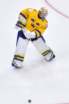 Jesper Wallstedt of Sweden clears the puck