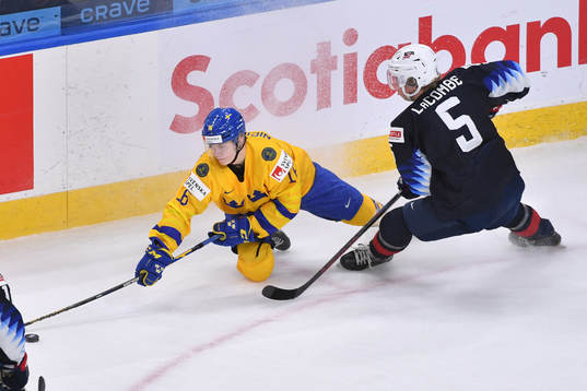 Theodor Niederbach of Sweden reaches for the puck while