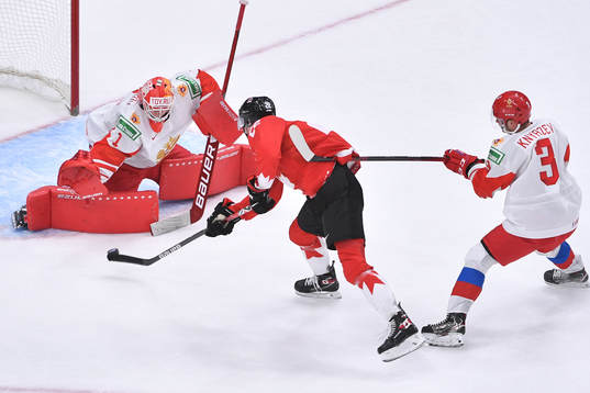 Artemi Knyazev of Russia hooks Dylan Cozens of Canada