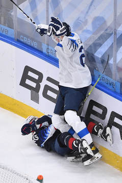 Samuel Helenius of Finland collides with Ryan Johnson of USA during the 2021 IIHF World Junior Championship semifinal between USA and Finland on January 4, 2021 in Edmonton.
