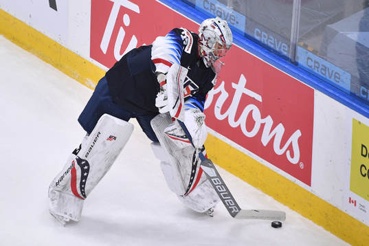 Spencer Knight of USA handles the puck