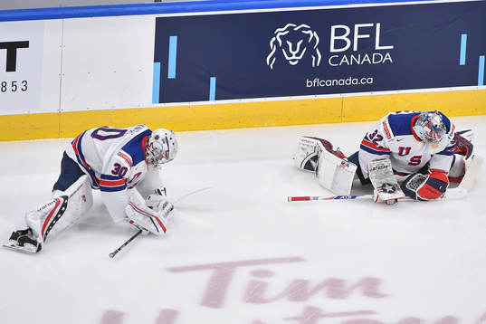 Dustin Wolf and Spencer Knight of USA stretch
