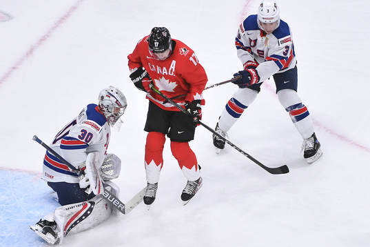 Connor McMichael of Canada attempts to tip the puck in