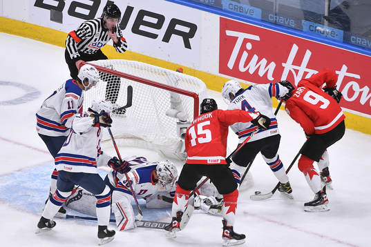 Connor Zary an Alex Newhook of Canada battle with Cam York,