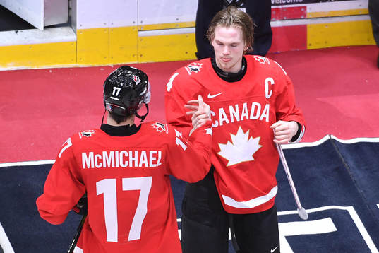 Team Canada captain Bowen Byram presents teammate Connor