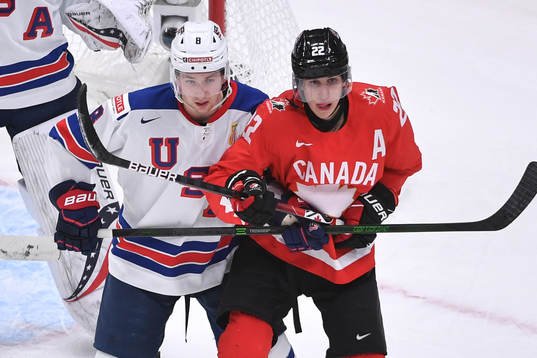 Dylan Cozens of Canada and Jake Sanderson of USA battle for