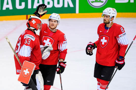 Goalkeeper Leonardo Genoni , Christoph Bertschy and Vincent