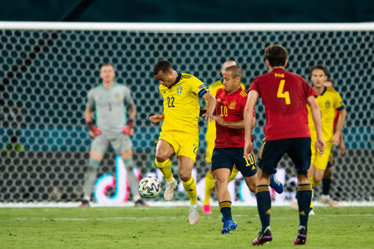 Robin Quaison of Sweden and Thiago Alcantara of Spain