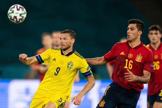 Marcus Berg of Sweden in action against Rodri of Spain
