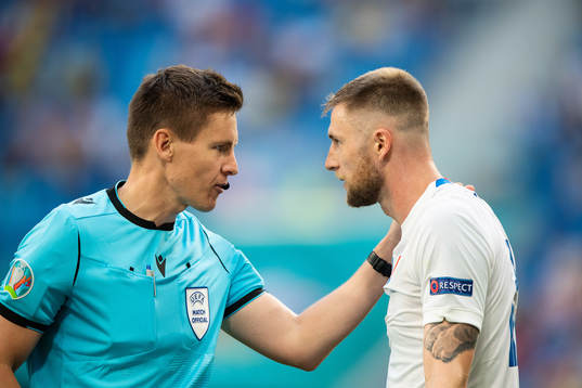 referee Daniel Siebert and Milan Skriniar of Slovakia
