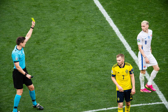 referee Daniel Siebert shows a yellow card to Ondrej Duda of Slovakia