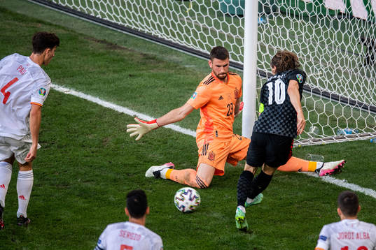 Goalkeeper Unai Simon of Spain and Luka Modric of Croatia