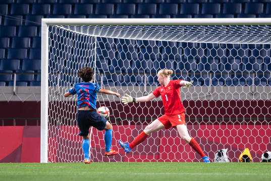 Mina Tanaka of Japan scores the 1-1 goal behind goalkeeper