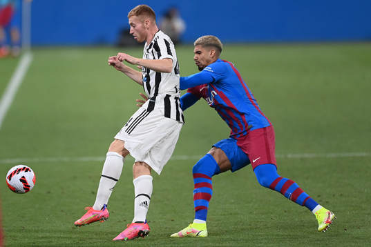 Dejan Kulusevski of Juventus and Ronald Araújo of Barcelona  during a friendly match between Juventus and Barcelona on August 2, 2021 in Barcelona.
