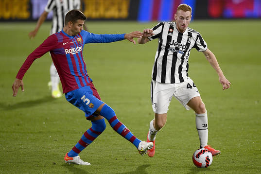 Gerard Piqué of Barcelona and Dejan Kulusevski of Juventus