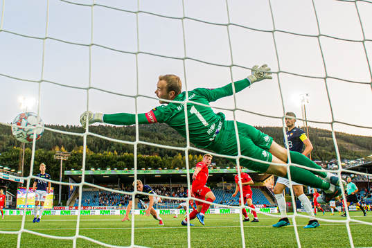 Aune Selland Heggebø of Brann scores the 0-1 goal behind Viljar Røsholt Myhra of Strømsgodset