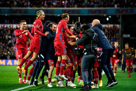 Ståle Solbakken, head coach of Norway, celebrates with the players after the 2-0 goal by Mohamed Elyounoussi, not pictured,