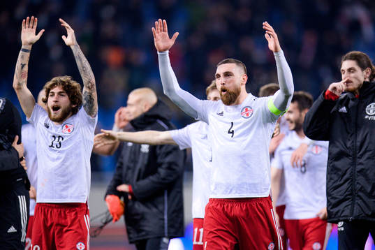 Giorgi Tsitaishvili and Guram Kashia of Georgia celebrate