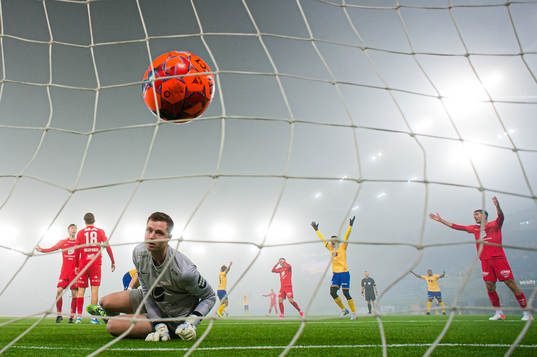 Torje Wichne of Jerv scores the 0-1 goal behind Hannes Lennart Grill of Brann