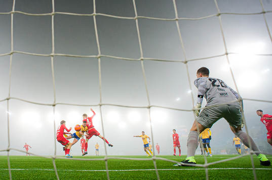 Torje Wichne of Jerv scores the 0-1 goal behind Hannes Lennart Grill of Brann