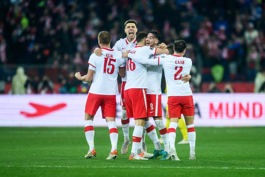Kamil Glik, Krystian Bielik, Jakub Moder and Matty Cash of Poland celebrate
