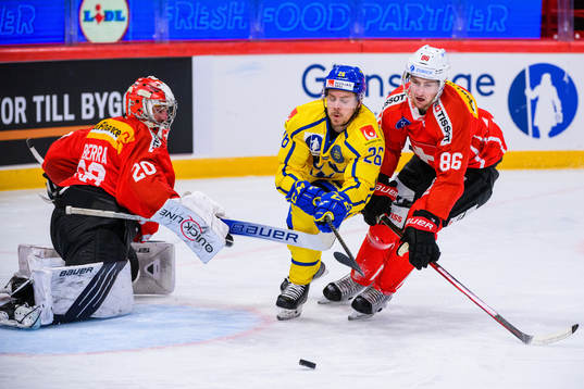 Joel Kellman of Sweden with Goalkeeper Reto Berra and Janis