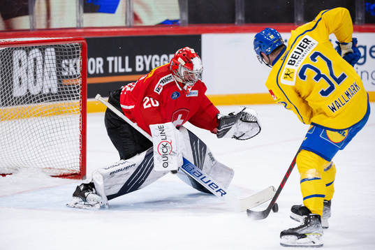 Lucas Wallmark of Sweden against goalkeeper Reto Berra of