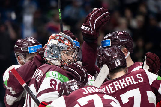 Goaltender Elvis Maerzlikins of Latvia celebrate with