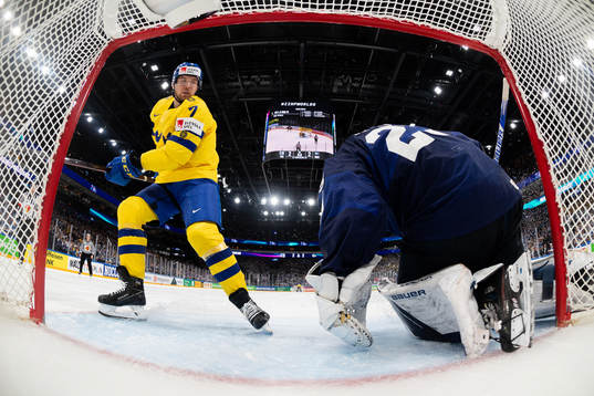 Henrik Tömmernes of Sweden against goaltender Harri