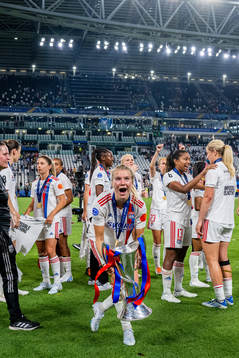 Ada Hegerberg of Lyon celebrates with the winners trophy