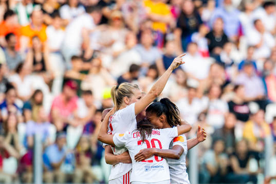 Ada Hegerberg of Lyon celebrates with teammates after scoring 0-2