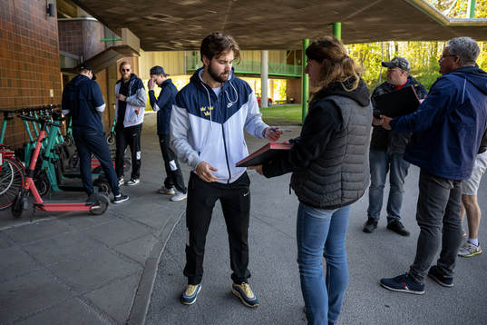 Emil Bemström of Sweden write autographs outside the hotel