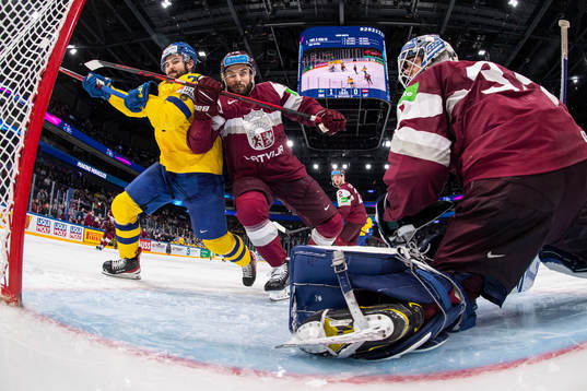 Emil Bemström of Sweden against Janis Jaks and goaltender