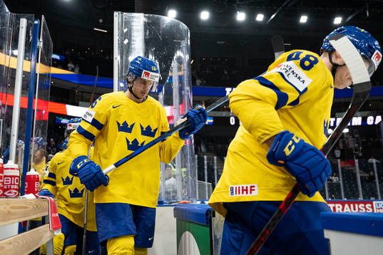 Nils Åman of Sweden enter the ice
