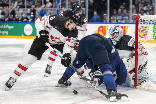 Travis Sanheim of Canada and Hannes Björninen of Finland