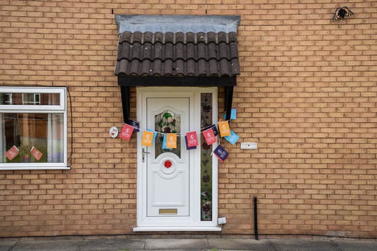 A front door decorated with Euro 2022 flags ahead of the UEFA Women's Euro 2022 group stage match between Sweden and Portugal on July 17, 2022 in Leigh. 
