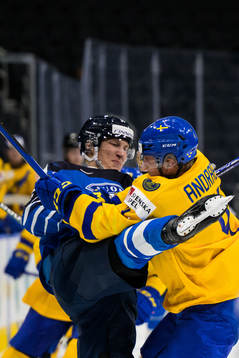 A Finnish player is being tackled by Emil Andrae of Sweden