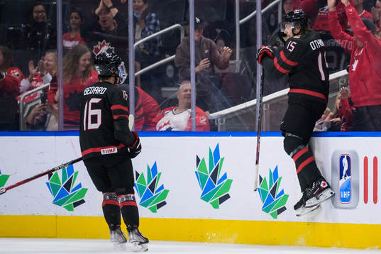 Connor Bedard and Brennan Othmann of Canada celebrate the