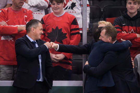 Head coach Tomas Montén fist bumps with video coach Adam