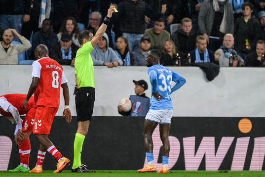 Mohamed Buya Turay of Malmö FF is shown a yellow card by Referee Duje Strukan