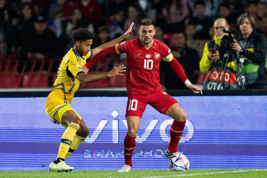 Jens Cajuste of Sweden and Dusan Tadic of Serbia