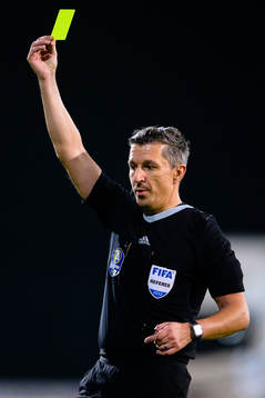 Domare Bojan Pandzic delar ut ett gult kort